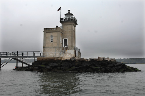 the huntington lighthouse sits by itself out at th