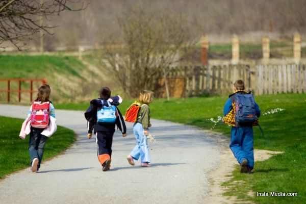 Two boys and two girls going to school