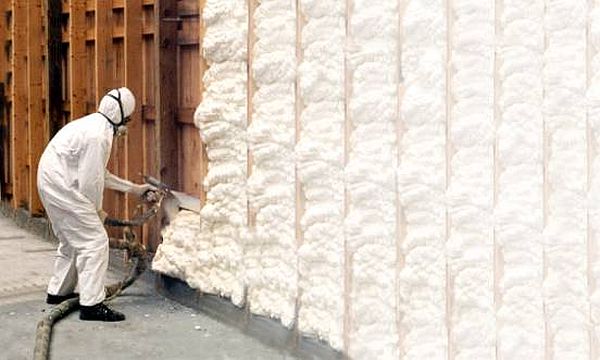 All-suited-up-a-worker-installs-spray-foam-building-insulation