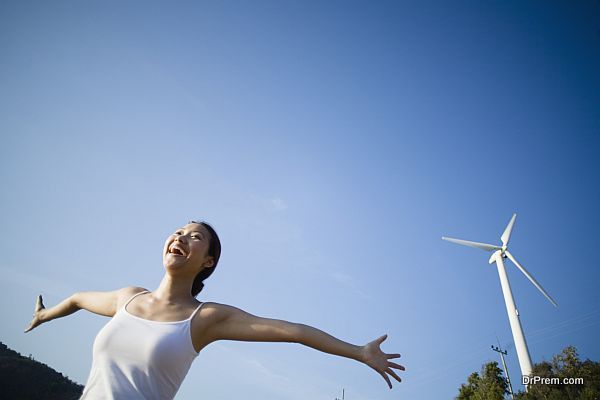 Young Woman by Wind Turbine