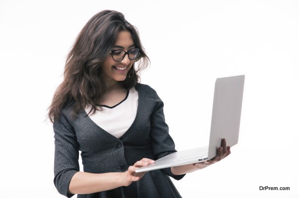 Smiling businesswoman in glasses using laptop isolated on a white background