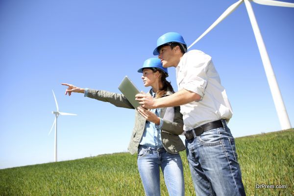 Engineers looking at wind turbine site with tablet