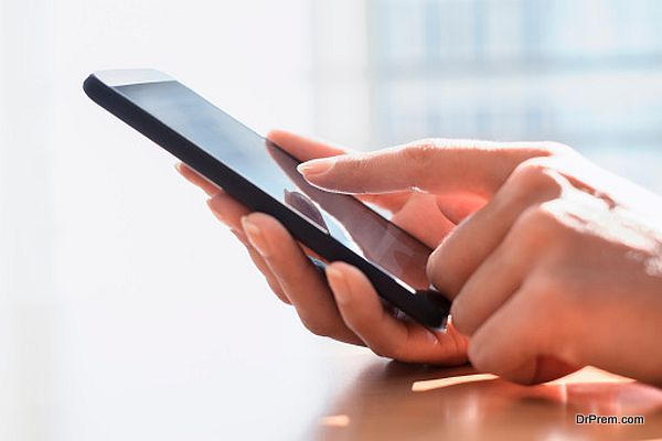 Close up of hands woman using her cell phone.