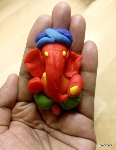 Ganesha idol in hand made of clay