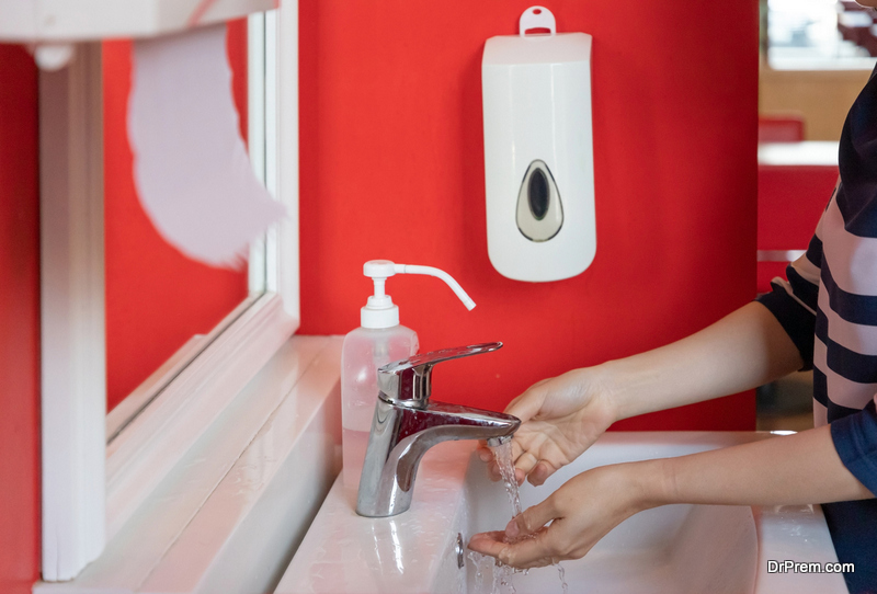 woman hand washing her hand with antibacterial soap and alcohol gel for prevention contaminate virus CORONA or flu in public toilet. concept : hygiene measures.