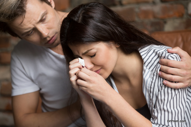 Man comforting crying sad woman