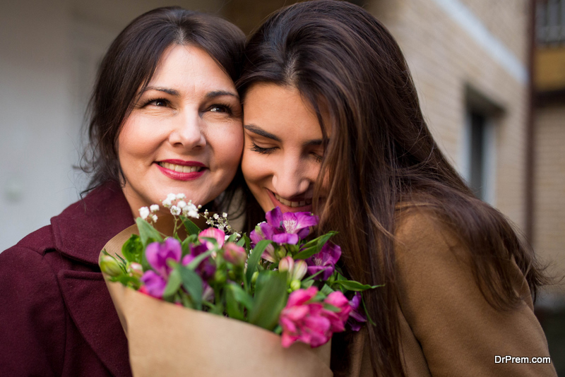 daughter gifting bouquet of spring flowers