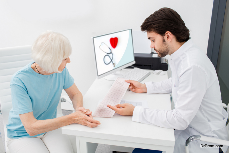 Cardiologist analyzes the electrocardiogram results of senior woman