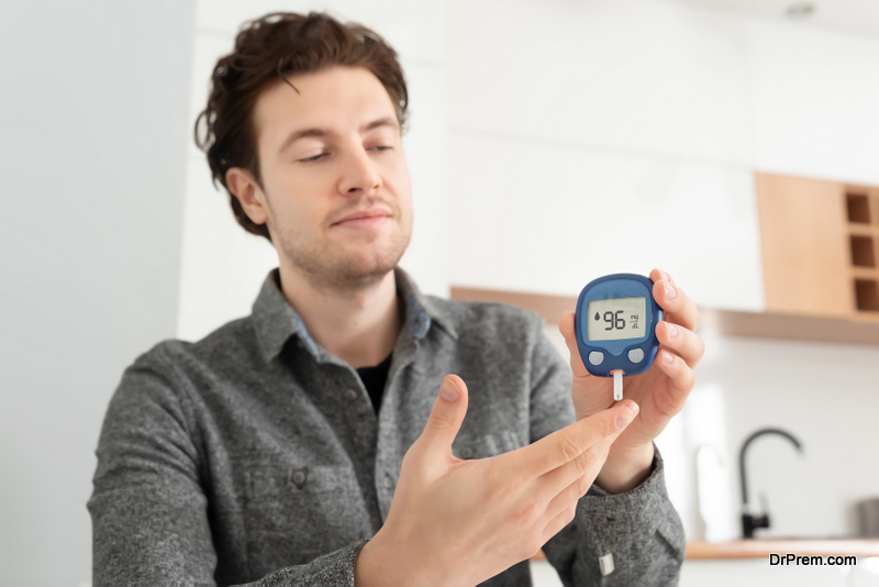 man checking blood sugar level