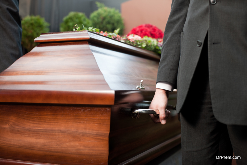 Dolor - Funeral with coffin on a cemetery, the casket carried by coffin bearer