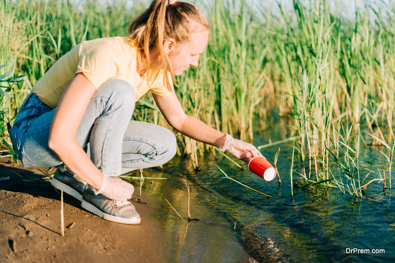 Young female volunteer satisfied with picking up trash