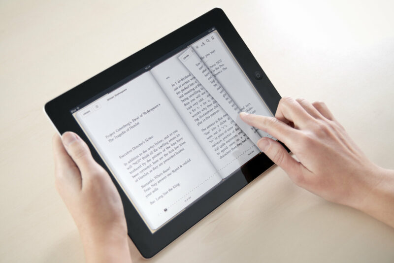 Person reading an e-book from an ipad